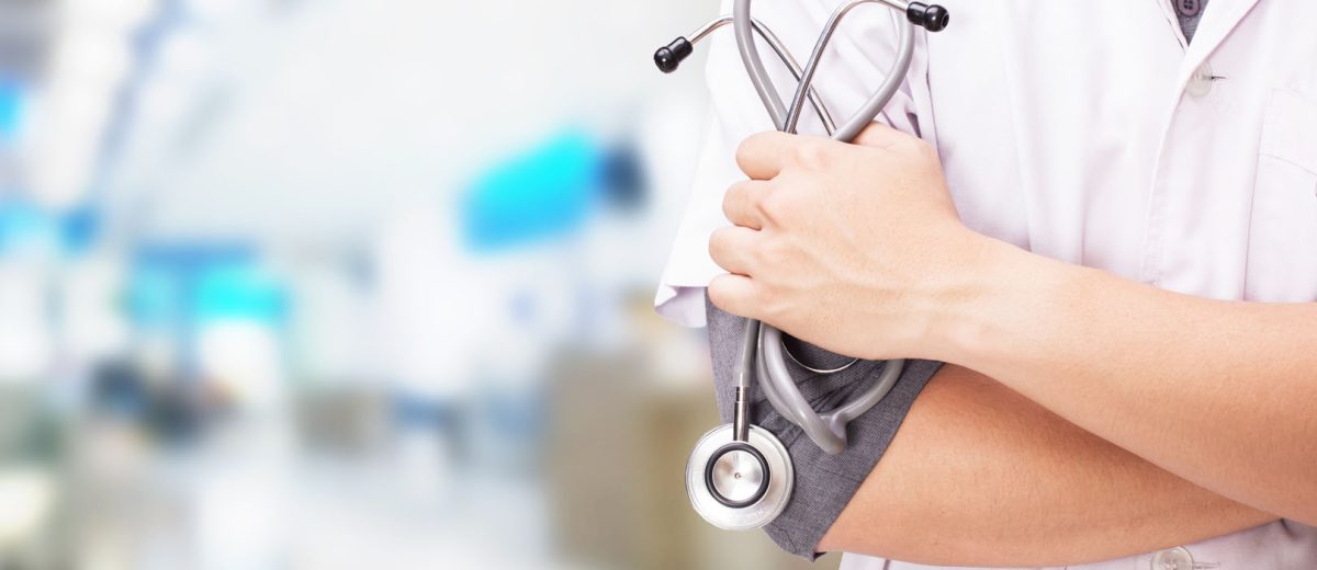 Doctor with a stethoscope in the hands and hospital background